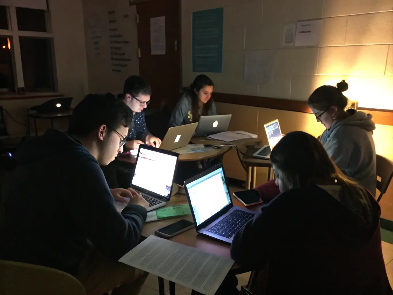 A classroom setting with students actively participating in a Python programming lesson, focusing on data manipulation and analysis.
